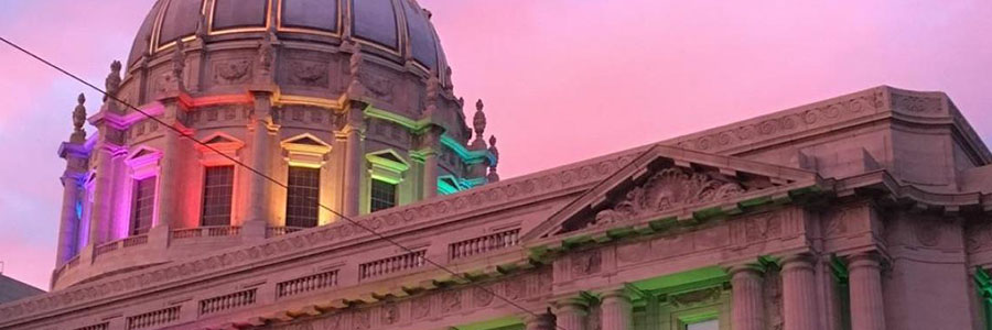 Picture of San Francisco City Hall lit up with rainbows for Pride